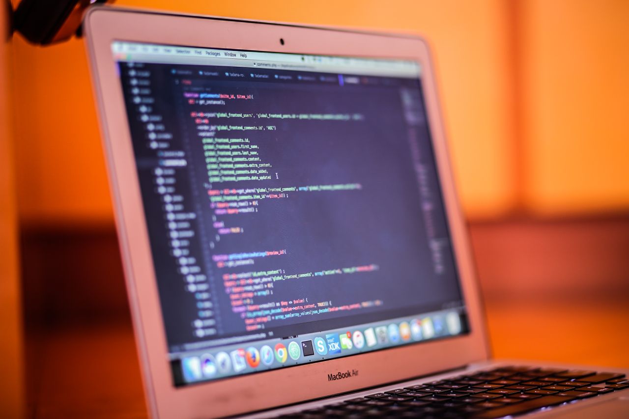 about-01 Focused shot of a laptop displaying code, suitable for tech and coding themes.